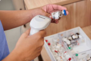 Pharmacy technician scanning an RFID tagged medication with a barcode scanner in a hospital